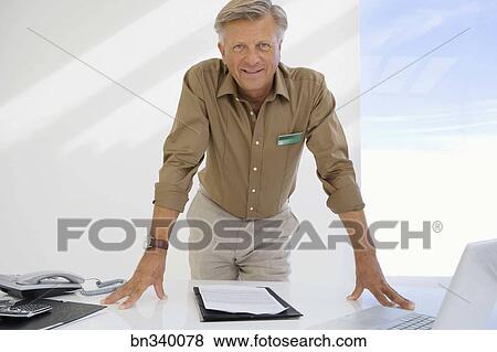Financial Adviser Standing At Desk Stock Photo Bn340078 Fotosearch