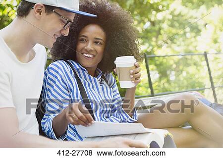 College students drinking coffee and studying in park View Large Photo Image Stock Photo - College students drinking coffee and studying in park. Fotosearch
