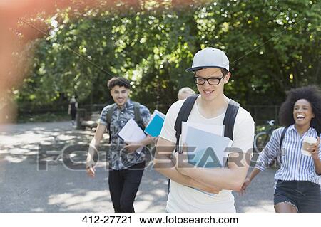 Stock Image - College students walking in park. Fotosearch