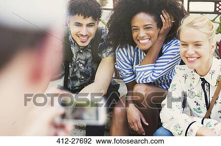Stock Image - Enthusiastic friends being photographed. Fotosearch