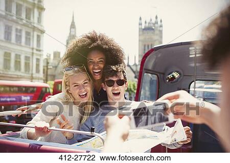 Enthusiastic friends being photographed on double-decker bus View Large Photo Image Stock Image - Enthusiastic friends being photographed on double-decker bus. Fotosearch