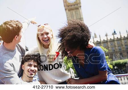 Enthusiastic friends laughing and pointing at Big Ben clocktower, London, United Kingdom View Large Photo Image Stock Image - Enthusiastic friends laughing and pointing at Big Ben clocktower, London, United Kingdom. Fotosearch
