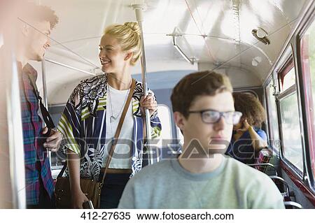 Stock Photography - Friends talking on bus. Fotosearch