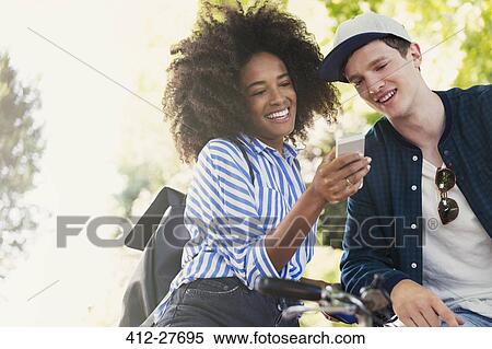 Friends texting with cell phone View Large Photo Image Stock Photography - Friends texting with cell phone. Fotosearch