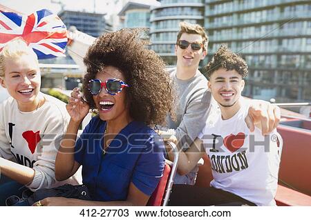 Portrait enthusiastic friends with British flag riding double-decker bus View Large Photo Image Stock Image - Portrait enthusiastic friends with British flag riding double-decker bus. Fotosearch