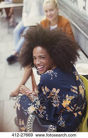Portrait enthusiastic woman with afro at sidewalk cafe View Large Photo Image Stock Photo - Portrait enthusiastic woman with afro at sidewalk cafe. Fotosearch