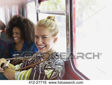 Stock Photograph - Portrait smiling blonde woman riding bus. Fotosearch