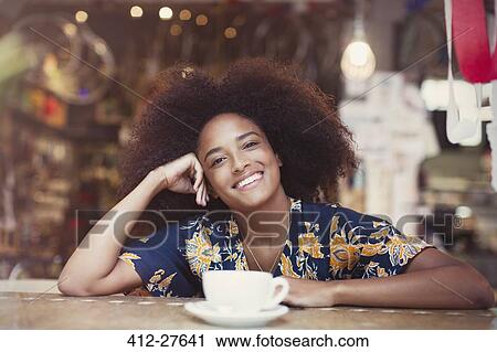 Portrait smiling woman with afro drinking coffee in cafe View Large Photo Image Stock Image - Portrait smiling woman with afro drinking coffee in cafe. Fotosearch