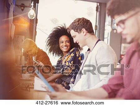 Smiling friends in cafe View Large Photo Image Stock Photograph - Smiling friends in cafe. Fotosearch