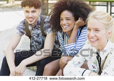Smiling friends looking away View Large Photo Image Stock Photo - Smiling friends looking away. Fotosearch