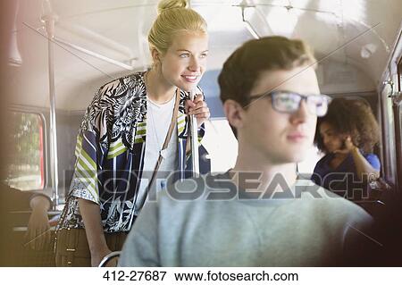 Smiling woman looking out bus window View Large Photo Image Stock Photo - Smiling woman looking out bus window. Fotosearch