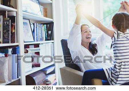 Enthusiastic mother and daughter holding hands overhead View Large Photo Image Stock Image - Enthusiastic mother and daughter holding hands overhead. Fotosearch