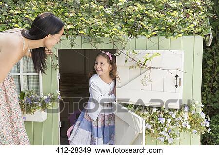 Mother and daughter at playhouse in garden View Large Photo Image Stock Photo - Mother and daughter at playhouse in garden. Fotosearch
