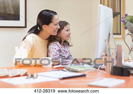 Stock Photo - Mother and daughter using computer. Fotosearch