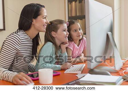 Mother and daughters using computer View Large Photo Image Stock Image - Mother and daughters using computer. Fotosearch