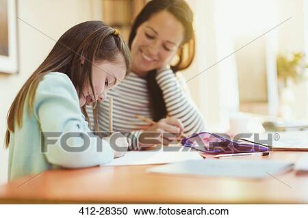Mother watching daughter do homework View Large Photo Image Stock Image - Mother watching daughter do homework. Fotosearch