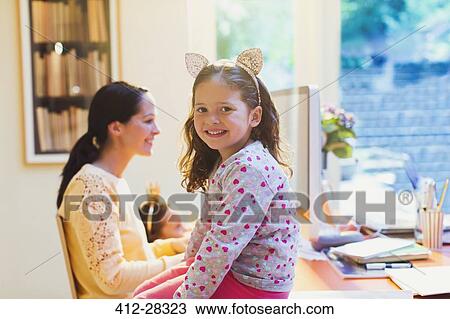 Stock Image - Portrait cute girl with mouse ears headband. Fotosearch