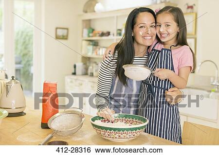 Portrait playful mother and daughter baking in kitchen with flour on faces View Large Photo Image Stock Photograph - Portrait playful mother and daughter baking in kitchen with flour on faces. Fotosearch
