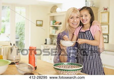 Portrait smiling grandmother and granddaughter baking in kitchen View Large Photo Image Stock Photography - Portrait smiling grandmother and granddaughter baking in kitchen. Fotosearch