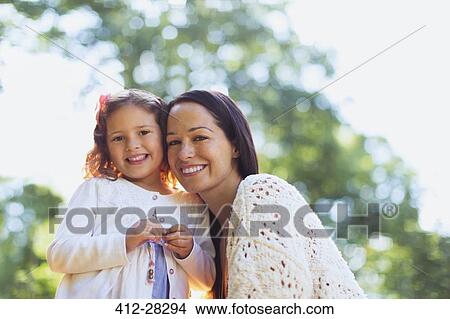 Picture - Portrait smiling mother and daughter outdoors. Fotosearch