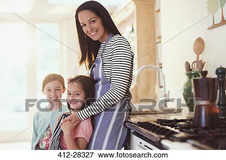 Portrait smiling mother and daughters in kitchen View Large Photo Image Stock Photo - Portrait smiling mother and daughters in kitchen. Fotosearch