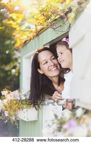 Smiling mother and daughter in playhouse window View Large Photo Image Stock Photo - Smiling mother and daughter in playhouse window. Fotosearch