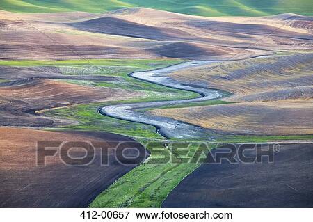 Stock Photo - Aerial view of river winding through landscape. Fotosearch