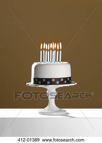 Birthday cake with lit candles on cake stand View Large Photo Image Stock Photo - Birthday cake with lit candles on cake stand. Fotosearch