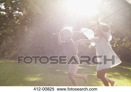 Boy and girl holding hands and running with butterfly nets in grass View Large Photo Image Stock Photography - Boy and girl holding hands and running with butterfly nets in grass. Fotosearch