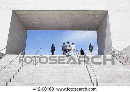 Stock Photo - Business people ascending concrete steps toward blue sky. Fotosearch