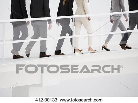 Stock Image - Business people ascending elevated walkway. Fotosearch