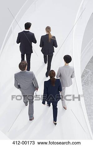 Business people ascending elevated walkway View Large Photo Image Stock Image - Business people ascending elevated walkway. Fotosearch