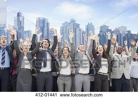 Business people cheering with arms raised in front of skyline View Large Photo Image Stock Image - Business people cheering with arms raised in front of skyline. Fotosearch