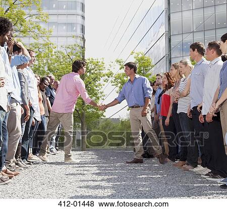 Business people from separate teams shaking hands View Large Photo Image Stock Photo - Business people from separate teams shaking hands. Fotosearch