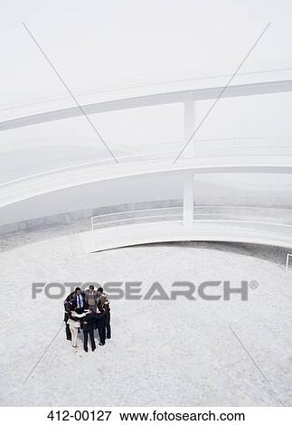 Business people meeting in huddle in courtyard View Large Photo Image Stock Photo - Business people meeting in huddle in courtyard. Fotosearch