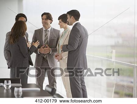 Business people talking at window of conference room View Large Photo Image Stock Photo - Business people talking at window of conference room. Fotosearch