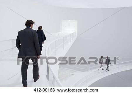 Business people walking along elevated walkways View Large Photo Image Stock Image - Business people walking along elevated walkways. Fotosearch