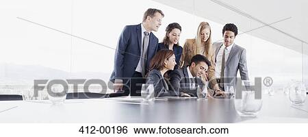 Business people watching businessman sign contract in conference room View Large Photo Image Stock Photograph - Business people watching businessman sign contract in conference room. Fotosearch