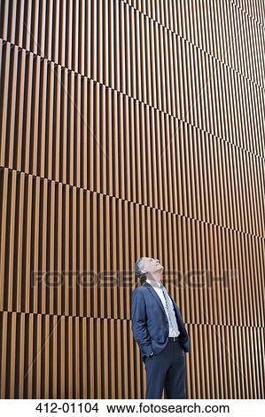 Businessman looking up View Large Photo Image Picture - Businessman looking up. Fotosearch