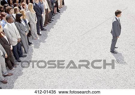 Businessman with back turned on crowd View Large Photo Image Stock Photography - Businessman with back turned on crowd. Fotosearch