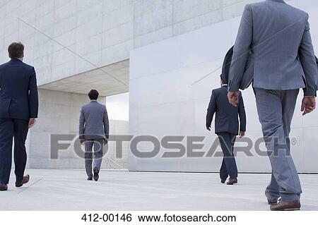 Businessmen walking toward cultural center View Large Photo Image Stock Photograph - Businessmen walking toward cultural center. Fotosearch