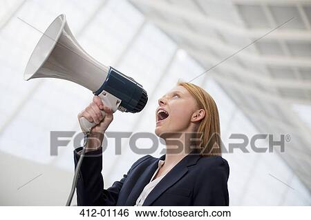 Businesswoman shouting into bullhorn View Large Photo Image Stock Photograph - Businesswoman shouting into bullhorn. Fotosearch