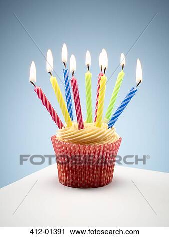 Close up of cupcake with lit birthday candles View Large Photo Image Stock Image - Close up of cupcake with lit birthday candles. Fotosearch