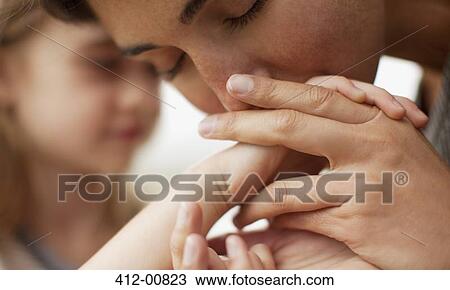 Close up of mother kissing daughter's han View Large Photo Image Stock Image - Close up of mother kissing daughter's han. Fotosearch