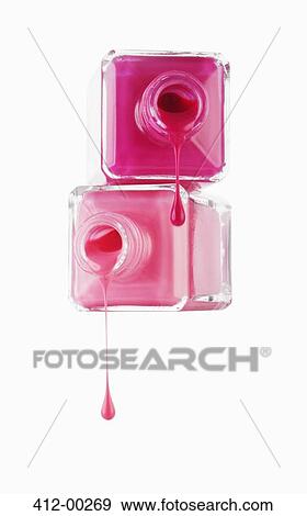 Close up of pink fingernail polish dripping from bottles View Large Photo Image Stock Photo - Close up of pink fingernail polish dripping from bottles. Fotosearch