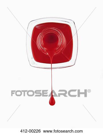 Stock Photograph - Close up of red fingernail polish dripping from bottle. Fotosearch