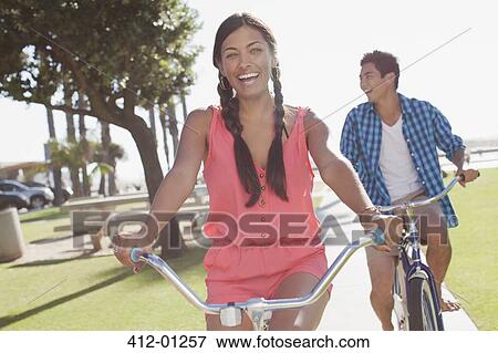 Couple riding bicycles outdoors View Large Photo Image Stock Photo - Couple riding bicycles outdoors. Fotosearch