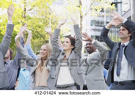 Crowd of business people cheering with arms raised View Large Photo Image Picture - Crowd of business people cheering with arms raised. Fotosearch