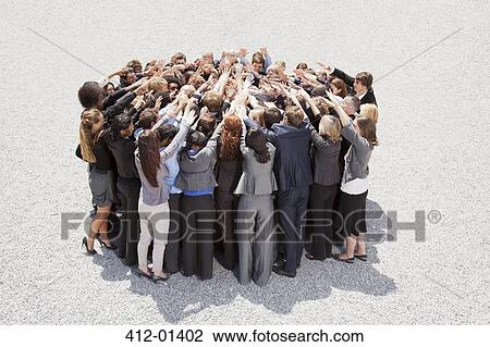 Crowd of business people in huddle View Large Photo Image Stock Image - Crowd of business people in huddle. Fotosearch