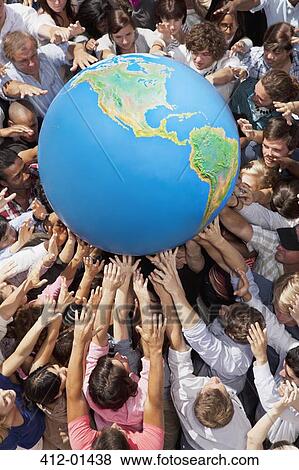 Crowd of people reaching for globe View Large Photo Image Stock Photo - Crowd of people reaching for globe. Fotosearch